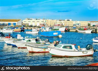 Peniche harbor, fishing boats in row, docks in background, Portugal