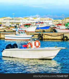 Peniche harbor, fishing boats, red buoy, docks in background, Portugal