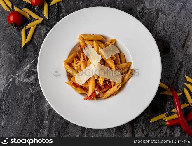 Penne pasta with a spicy sauce, chili pepper and grated parmesan cheese. penne with parmesan