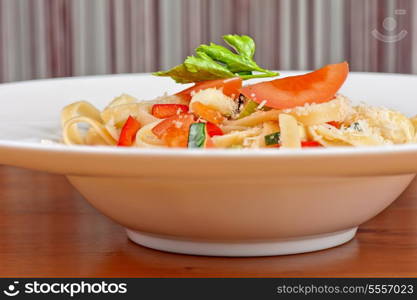 Penne pasta with parmesan cheese, herbs, tomatoes and basil