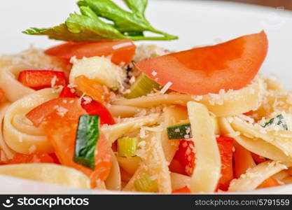 Penne pasta with parmesan cheese, herbs, tomatoes and basil