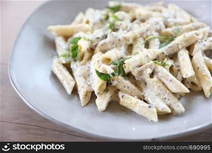 Penne pasta with white sauce and truffle , italian food