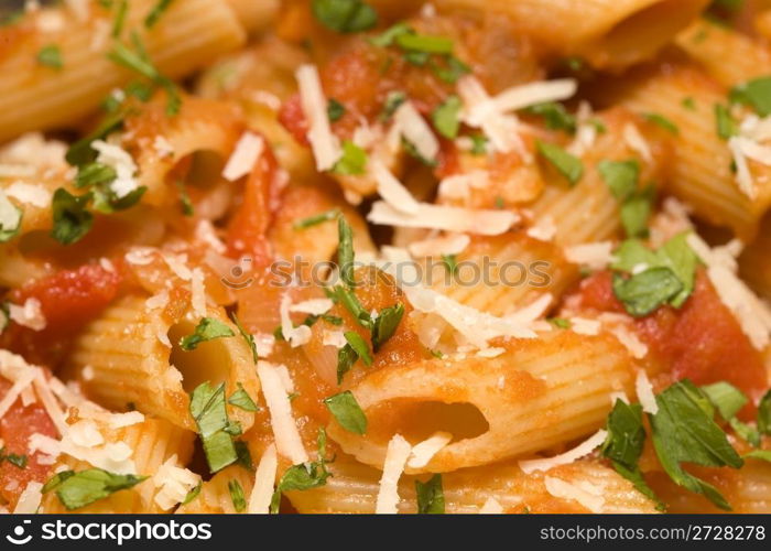 Penne rigate pasta with tomato sauce and cheese. background