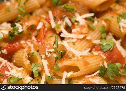 Penne rigate pasta with tomato sauce and cheese. background