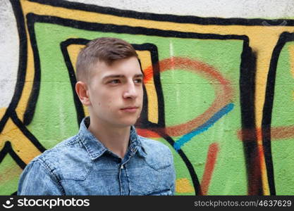 Pensive and funny teenager on a wall with graffiti background