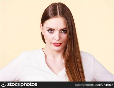 Pensive attractive brunette woman with full makeup having serious, thinking face expression.. Pensive thinking attractive brunette woman
