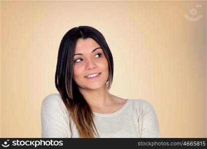Pensive attractive girl isolated on orange background