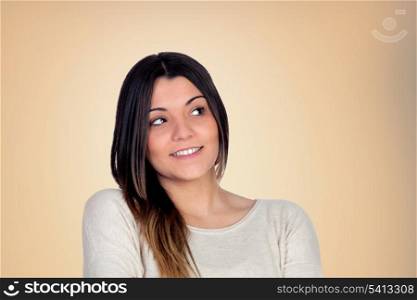 Pensive attractive girl isolated on orange background