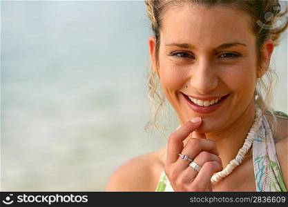 Pensive blond woman at the beach