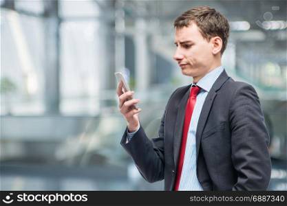 Pensive boss with phone in hand