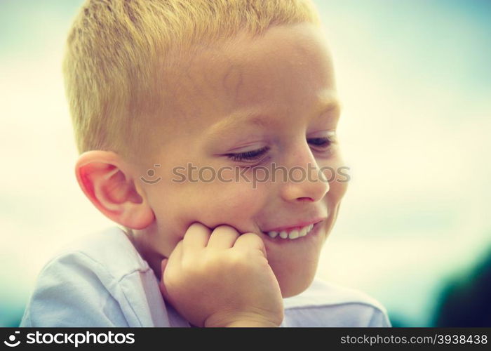 Pensive boy child thinking and daydreaming. Thoughtful kid leaning on his hand looking forward. Imagination.. Pensive boy child thinking and daydreaming.