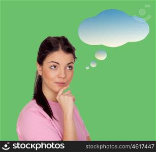 Pensive brunette girl isolated on a green background