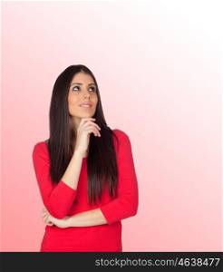 Pensive brunette girl isolated on a over red background