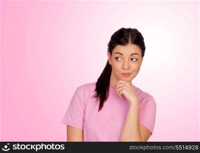 Pensive brunette girl isolated on a pink background
