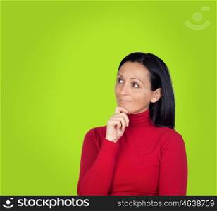 Pensive brunette woman on a over green background