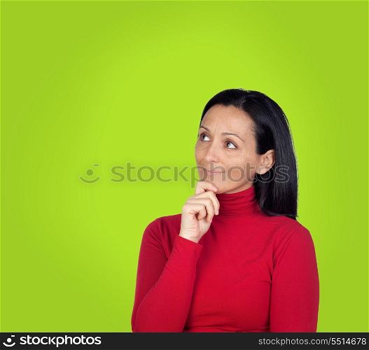 Pensive brunette woman on a over green background