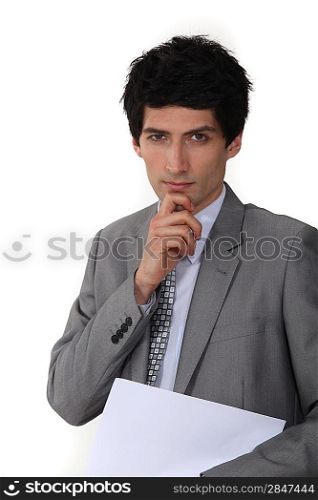 Pensive businessman holding paperwork
