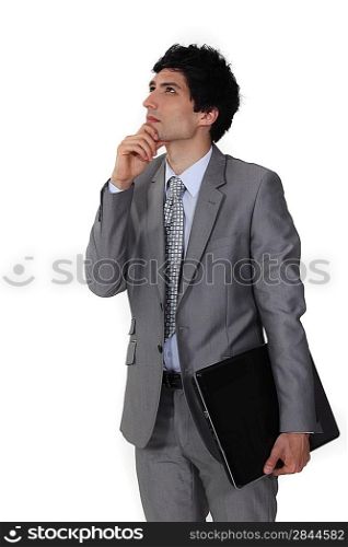 Pensive businessman rubbing his chin