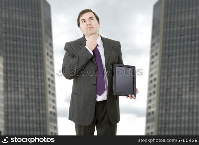 pensive businessman using a tablet pc, at the office