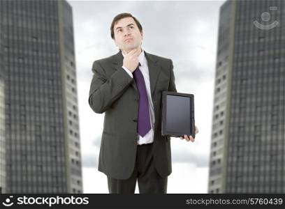 pensive businessman using a tablet pc, at the office