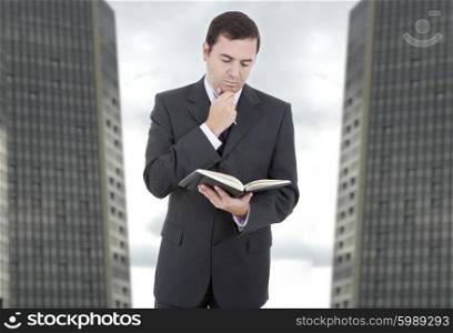 pensive businessman with a book at the office