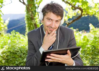 pensive businessman with digital tablet, outdoors