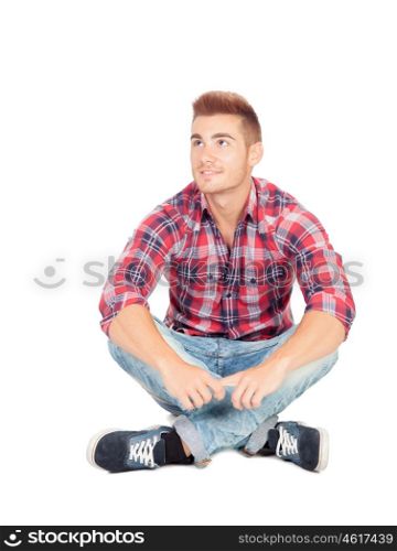 Pensive casual boy sitting on the floor isolated on white background