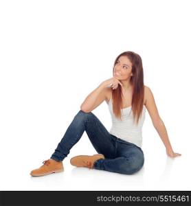 Pensive casual young woman sitting on the floor isolated on a white background