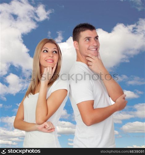 Pensive couple with a blue sky of background