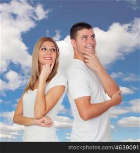 Pensive couple with a blue sky of background