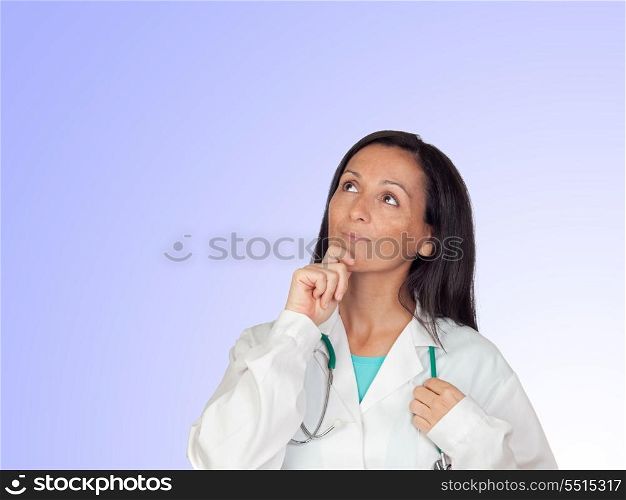 Pensive doctor woman isolated on a over blue background with focus on the hand