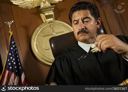 Pensive judge sitting in court