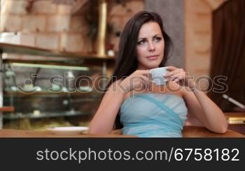 pensive lady drinking coffee in a coffee shop