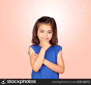 Pensive little girl isolated on a over orange background