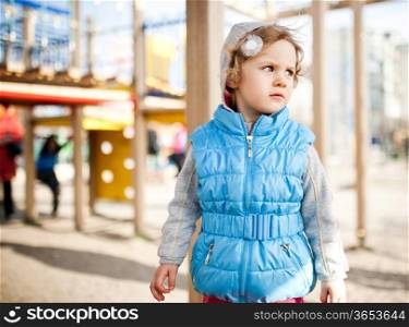 Pensive Little girl on playground area
