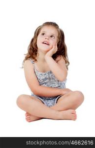Pensive little girl with three year old sitting on the floor isolated on a white background