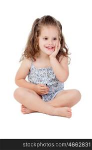 Pensive little girl with three year old sitting on the floor isolated on a white background