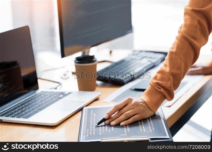 Pensive programmer working on on desktop pc programming code technologies or website design at office Software Development Company.