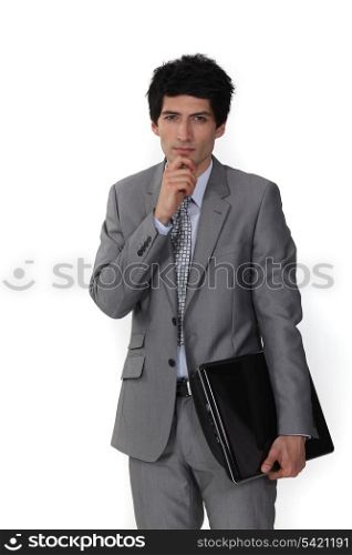 Pensive salesman holding folder