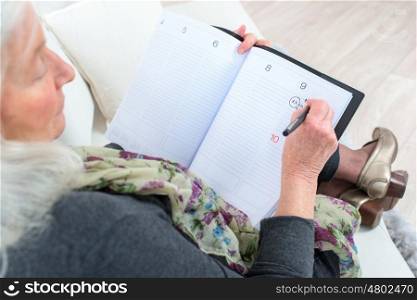 Pensive senior with a notepad