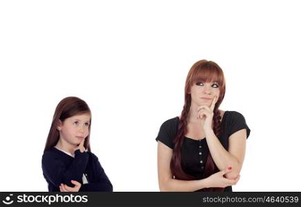 Pensive teenage girl dressed in black with a little sister isolated on white background