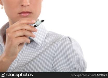 Pensive woman holding pen