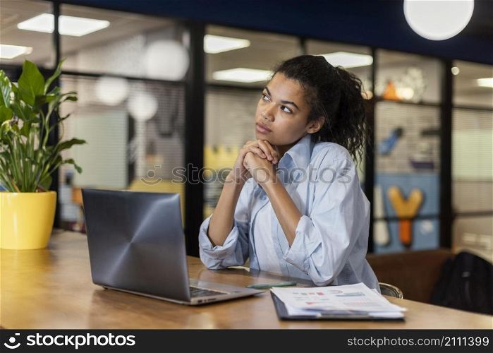 pensive woman office with laptop