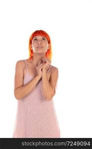 Pensive woman with red hair and pink dress isolated on a white background