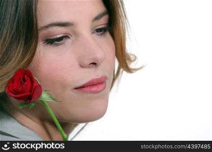 Pensive woman with red rose