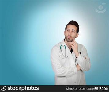 Pensive young doctor isolated on blue background