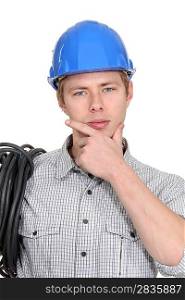 Pensive young electrician
