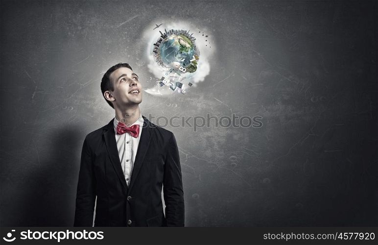 Pensive young man . Handsome young man in suit on concrete background looking up. Elements of this image are furnished by NASA