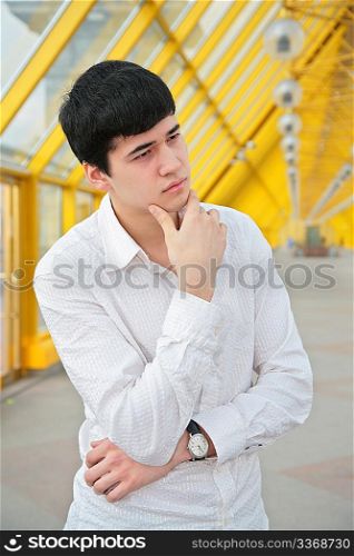 pensive young man on footbridge