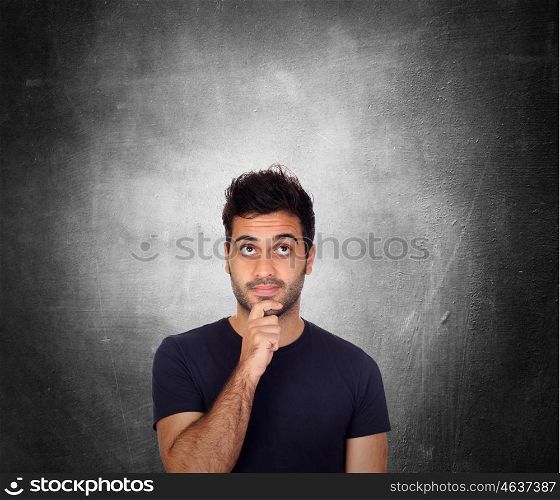 Pensive young men in black over a irregular gray background